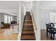 View of the staircase leading to the upper floor, showcasing hardwood treads and a bright, open design at 1090 Fountain Head Ln, Lawrenceville, GA 30043