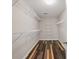 A walk-in closet features shelving and patterned, wood-look floors at 1090 Fountain Head Ln, Lawrenceville, GA 30043