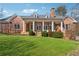 Beautiful backyard featuring a brick home with a covered porch and lush green lawn at 2850 Brandy Ln, Cumming, GA 30041
