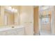 Well-lit bathroom featuring a white vanity with gold hardware, a large mirror, and a shower/tub combo at 2850 Brandy Ln, Cumming, GA 30041