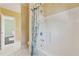 Bathroom with a white shower and floral shower curtain, tile floors, and view into another room at 2850 Brandy Ln, Cumming, GA 30041