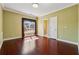Bright bedroom featuring hardwood floors, neutral walls, window with sunlight, and white trim at 2850 Brandy Ln, Cumming, GA 30041