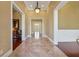 Grand foyer with stone tile flooring, elegant lighting, and views into adjacent rooms at 2850 Brandy Ln, Cumming, GA 30041