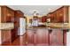 Kitchen featuring dark wood cabinets, granite countertops, and stainless steel appliances at 2850 Brandy Ln, Cumming, GA 30041