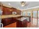 Bright and open kitchen with dark wood cabinets, granite countertops, and a center island at 2850 Brandy Ln, Cumming, GA 30041
