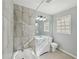 Bathroom featuring a tiled shower, vanity, and natural light, creating a clean and functional space at 10152 Griffin Sw Ln, Covington, GA 30014