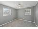 Well-lit bedroom with natural light featuring neutral walls and plush carpeting, creating a cozy retreat at 10152 Griffin Sw Ln, Covington, GA 30014