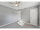 Well-lit bedroom with soothing gray walls and plush carpeting for a peaceful and inviting sanctuary at 10152 Griffin Sw Ln, Covington, GA 30014