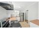 Bright kitchen with stainless steel appliances, white cabinets, and butcher block countertops at 10152 Griffin Sw Ln, Covington, GA 30014