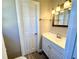 Bathroom featuring a modern vanity with a light fixture and a door at 1091 Mountain View Nw Rd, Conyers, GA 30012