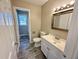 Bathroom with vinyl floors, modern vanity, and framed mirror at 1091 Mountain View Nw Rd, Conyers, GA 30012