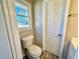 Bathroom with a toilet next to the window, showcasing natural light at 1091 Mountain View Nw Rd, Conyers, GA 30012