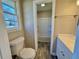Bathroom featuring a toilet, window, and a peek at a tub/shower combo at 1091 Mountain View Nw Rd, Conyers, GA 30012