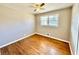Cozy bedroom featuring hardwood floors, neutral paint, and a window for natural light at 1091 Mountain View Nw Rd, Conyers, GA 30012