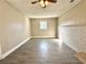 Large room with gray vinyl floors, bead board walls and a ceiling fan at 1091 Mountain View Nw Rd, Conyers, GA 30012