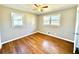 Bright bedroom with hardwood floors and two windows providing ample natural light at 1091 Mountain View Nw Rd, Conyers, GA 30012