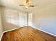 Neutral bedroom with hardwood floors, ceiling fan, and a double door closet at 1091 Mountain View Nw Rd, Conyers, GA 30012