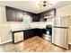 Modern kitchen with stainless steel appliances, contrasting countertops, and a stylish lighting fixture at 1091 Mountain View Nw Rd, Conyers, GA 30012