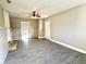 An open living room with a small brick fireplace and gray vinyl floors at 1091 Mountain View Nw Rd, Conyers, GA 30012