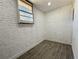 White brick room with a window and gray vinyl floors at 1091 Mountain View Nw Rd, Conyers, GA 30012