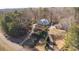 Wide aerial shot of a suburban home with a long winding driveway and surrounded by mature trees at 210 Wrights Mill Way, Canton, GA 30115