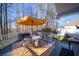 Rear covered porch with outdoor dining and seating area overlooking the meticulously landscaped yard at 210 Wrights Mill Way, Canton, GA 30115