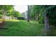 Spacious backyard with a well-maintained lawn, white picket fence, and mature trees at 210 Wrights Mill Way, Canton, GA 30115
