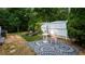 Outdoor living space with comfortable lounge chairs, a decorative rug, and lush greenery at 210 Wrights Mill Way, Canton, GA 30115