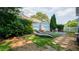 Inviting backyard patio area featuring lounge chairs, decorative fencing, and lush greenery at 210 Wrights Mill Way, Canton, GA 30115