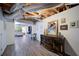 Basement area featuring an exposed ceiling, laminate flooring, and an eclectic cabinet against the wall at 210 Wrights Mill Way, Canton, GA 30115