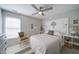 Serene bedroom with a ceiling fan, large window, neutral tones, and unique decorative headboard at 210 Wrights Mill Way, Canton, GA 30115