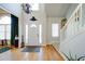 Bright foyer boasts hardwood floors, a soaring ceiling, and natural light from the door and window at 210 Wrights Mill Way, Canton, GA 30115