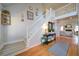 Foyer features hardwood floors, a staircase with white railings, and views of the living room at 210 Wrights Mill Way, Canton, GA 30115