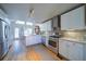 Spacious kitchen with white cabinets, stainless steel appliances, and an eat-in dining area at 210 Wrights Mill Way, Canton, GA 30115
