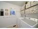 Functional laundry room with washer, dryer, and built-in shelving for storage at 210 Wrights Mill Way, Canton, GA 30115
