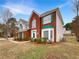 This brick home with white siding and green shutters is a classic beauty at 2180 Sugarbirch Dr, Lawrenceville, GA 30044