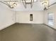 Spacious two-car garage with updated lighting, doors to enter the home, and smooth epoxy flooring at 2180 Sugarbirch Dr, Lawrenceville, GA 30044