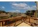 Spacious back deck offering a relaxing outdoor space with scenic views of the neighborhood and a bright blue sky at 4594 Marching Ln, Fairburn, GA 30213