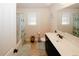 Bright bathroom with a single sink vanity, a tub-shower combo, and neutral-toned walls at 4594 Marching Ln, Fairburn, GA 30213