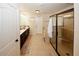 Hallway bathroom with a glass enclosed shower, a tub, and double-sink vanity at 4594 Marching Ln, Fairburn, GA 30213