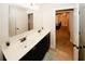 Bathroom featuring a double sink vanity and a view into the hallway at 4594 Marching Ln, Fairburn, GA 30213