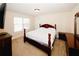 Bright bedroom with a large window, wood accents, and cozy furniture at 4594 Marching Ln, Fairburn, GA 30213