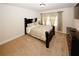 Bedroom featuring a dark-toned bed frame, neutral walls, and a dresser at 4594 Marching Ln, Fairburn, GA 30213