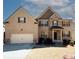 Charming two-story brick home with a two-car garage and well-maintained landscaping at 4594 Marching Ln, Fairburn, GA 30213