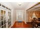 Inviting home foyer featuring hardwood floors and decorative glass french doors at 4594 Marching Ln, Fairburn, GA 30213