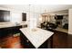 Spacious kitchen featuring dark cabinets, a granite island, stainless steel appliances and an open floor plan at 4594 Marching Ln, Fairburn, GA 30213