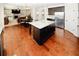 Bright kitchen with a large island, stainless steel refrigerator and dark hardwood floors at 4594 Marching Ln, Fairburn, GA 30213