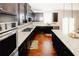 Modern kitchen boasts stainless steel appliances, granite countertops, dark cabinets and hardwood floors at 4594 Marching Ln, Fairburn, GA 30213