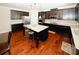 Well-equipped kitchen with a large island, stainless steel appliances and dark cabinets at 4594 Marching Ln, Fairburn, GA 30213