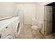 Utility area with a washing machine, dryer, and a standing shower, for added convenience in a functional space at 4594 Marching Ln, Fairburn, GA 30213